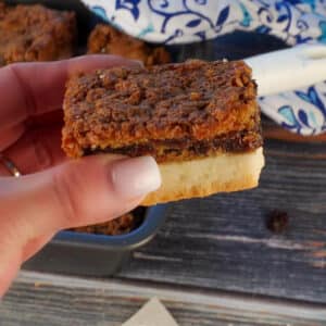 Butter tart square being held up in a hand