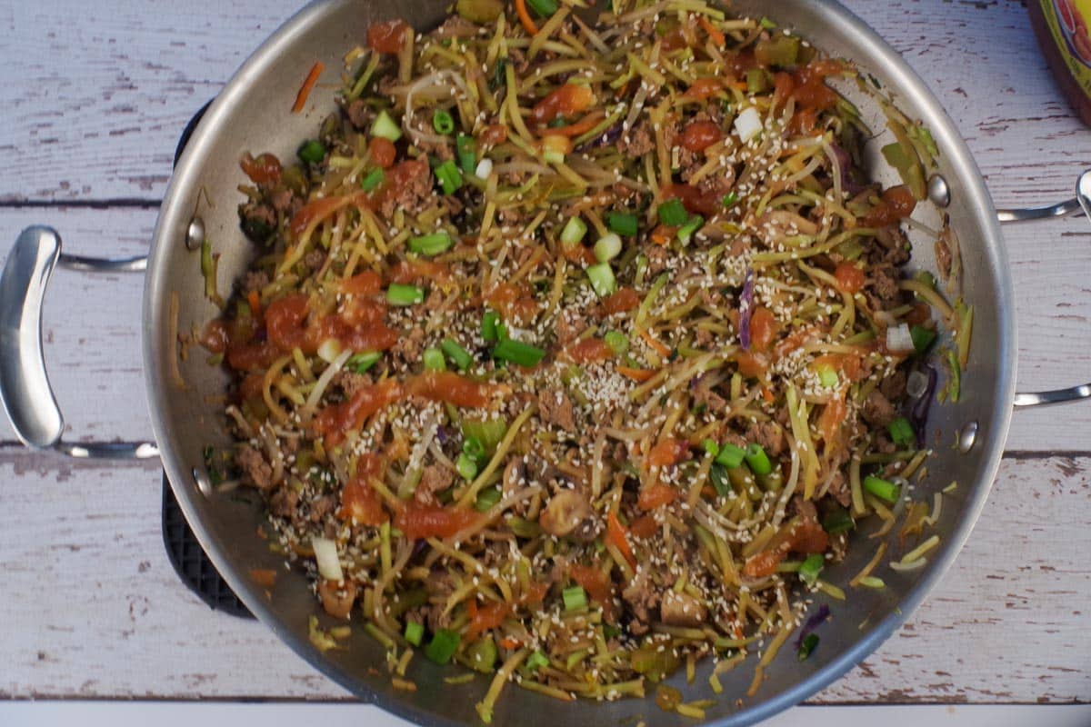 Cooked and garnished ww egg roll in a bowl in wok.