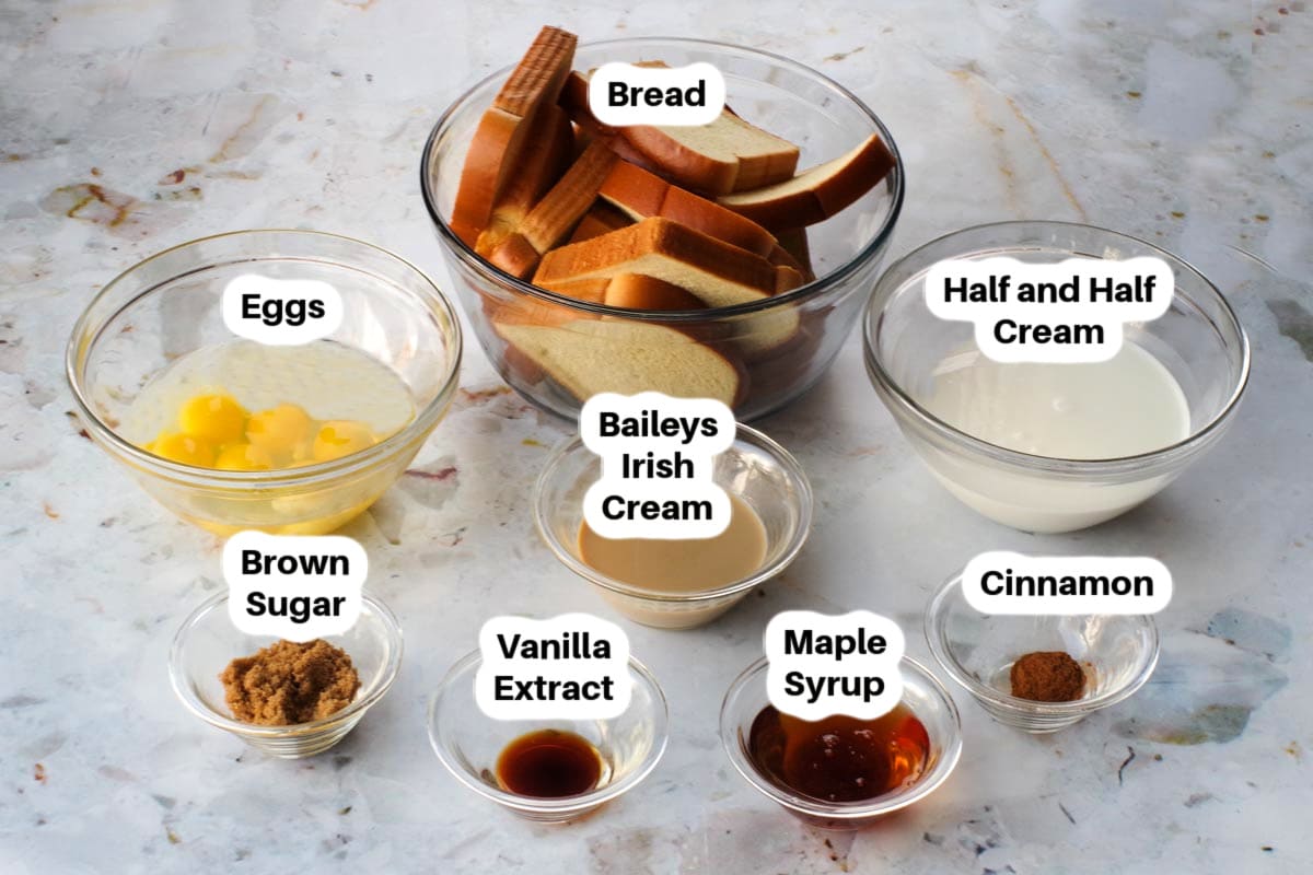 Ingredients needed for Baileys French Toast Casserole in glass bowls, labelled.