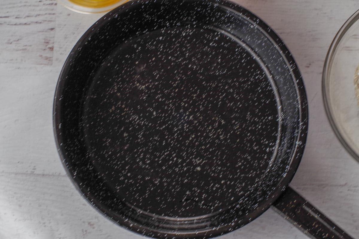 Olive oil heated in skillet.