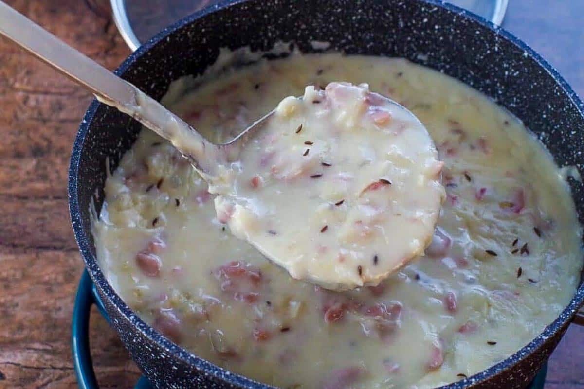 Reuben soup being scooped out with ladle