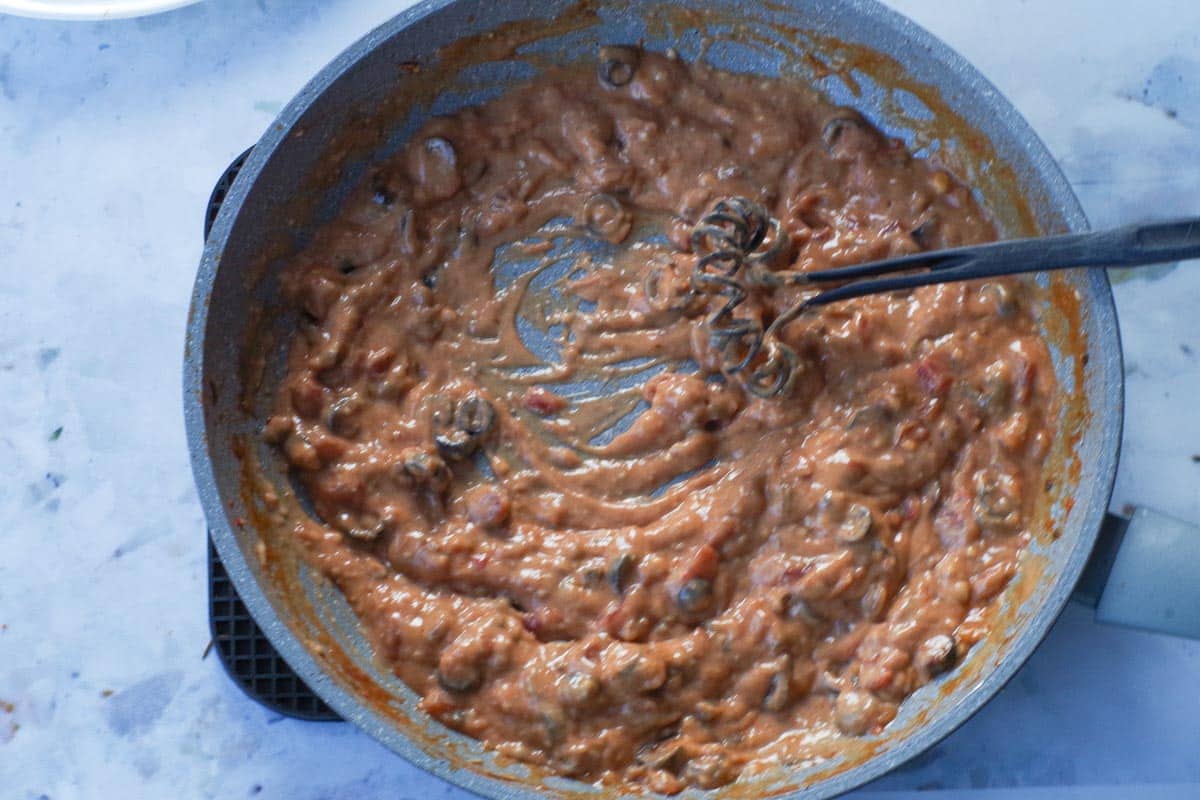 Pork removed from frying pan and cream of mushroom soup whisked into salsa mixture.