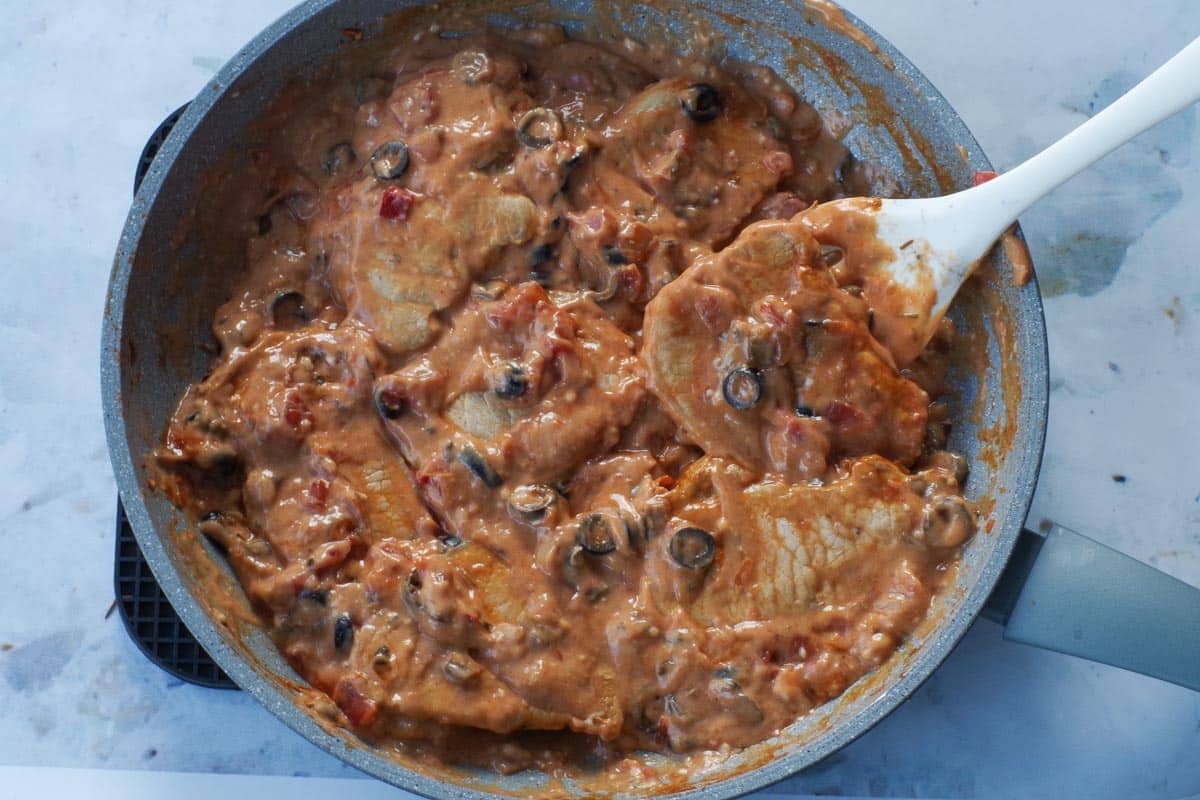 Pork added back into mushroom salsa sauce in frying pan.