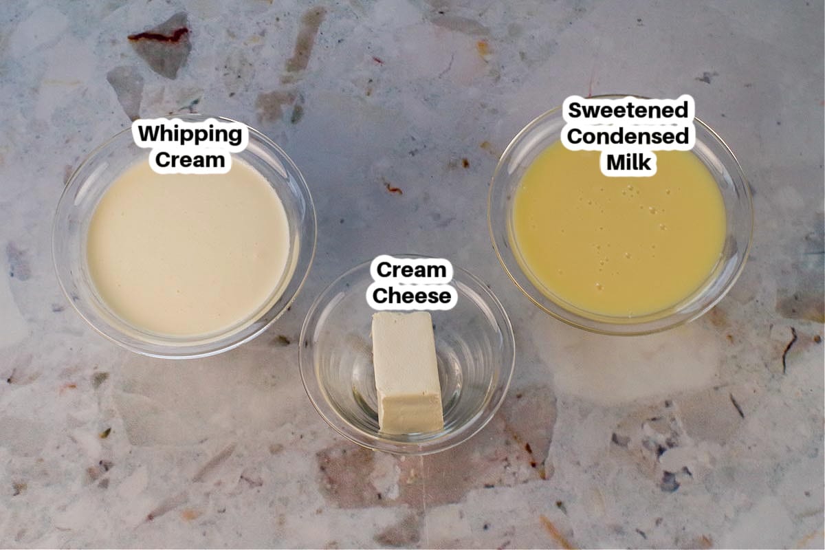 Ingredients needed for Red Velvet Ice Cream Cake Ice Cream Filling Ingredients in glass bowls, labelled.