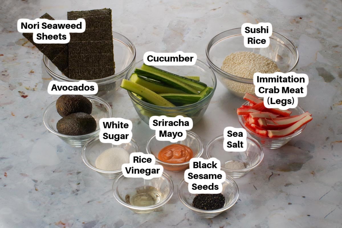 Ingredients needed for homemade California rolls in glass bowls, labelled.