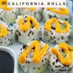 Photo of California rolls on a platter with soy sauce on the side and sriracha mayo drizzled on the rolls.