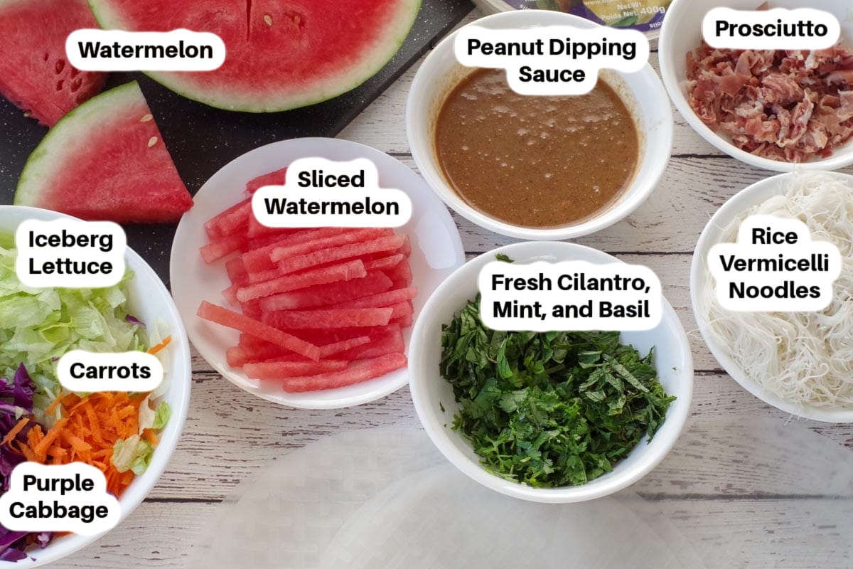 Ingredients in Vietnamese Salad Rolls with peanut dippng sauce in white bowls, labelled.