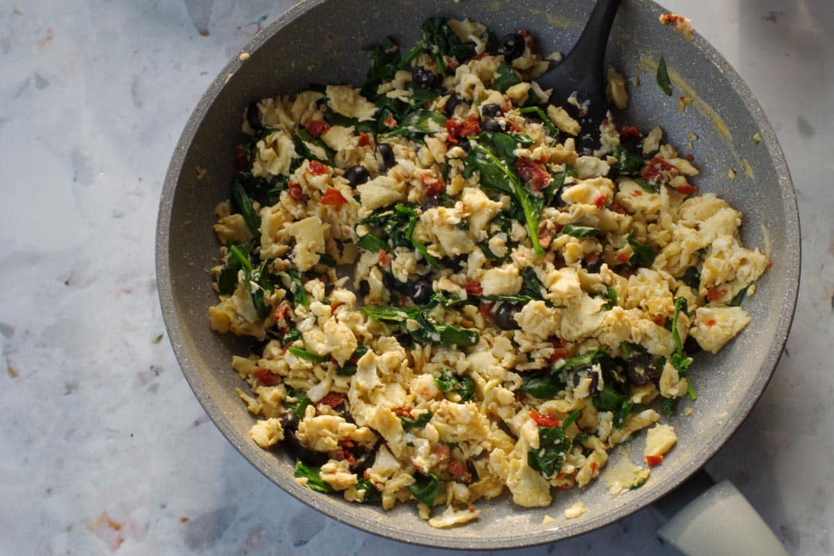 Egg mixture (with sun-dried tomatoes, olives and spinach ) no longer "wet" in frying pan.