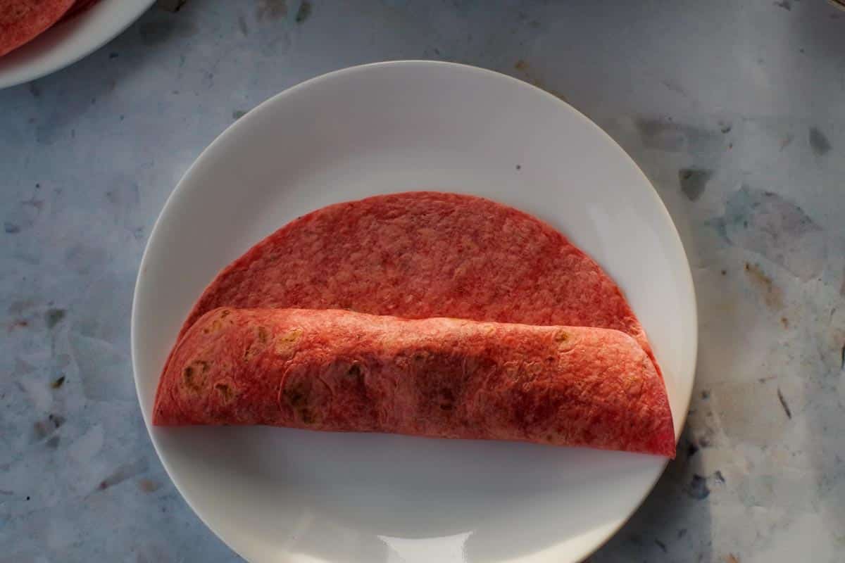 Tortilla folded to the centre from the bottom.