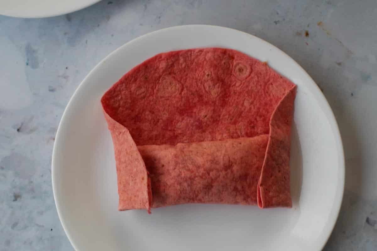 Each end folded towards the center.