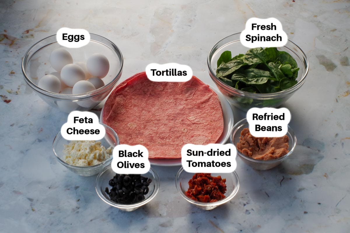 Mediterranean Breakfast Burrito ingredients in glass bowls, labelled.