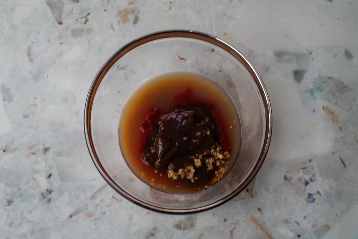 Barbeque sauce with Ketchup and Brown Sugar ingredients in a glass bowl.