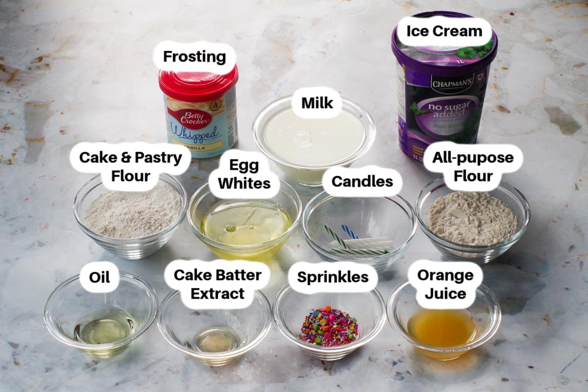 Ingredients needed for birthday cake crepes, in glass bowls, labelled.