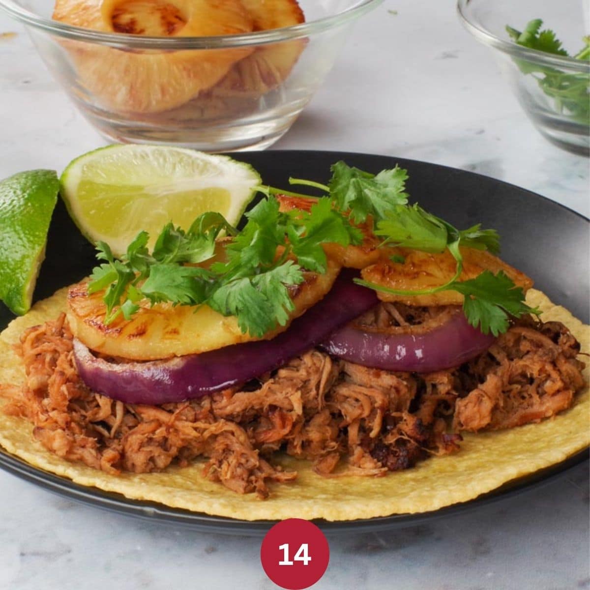 Assembled Crock Pot Pineapple Pork Carnita on a black plate.