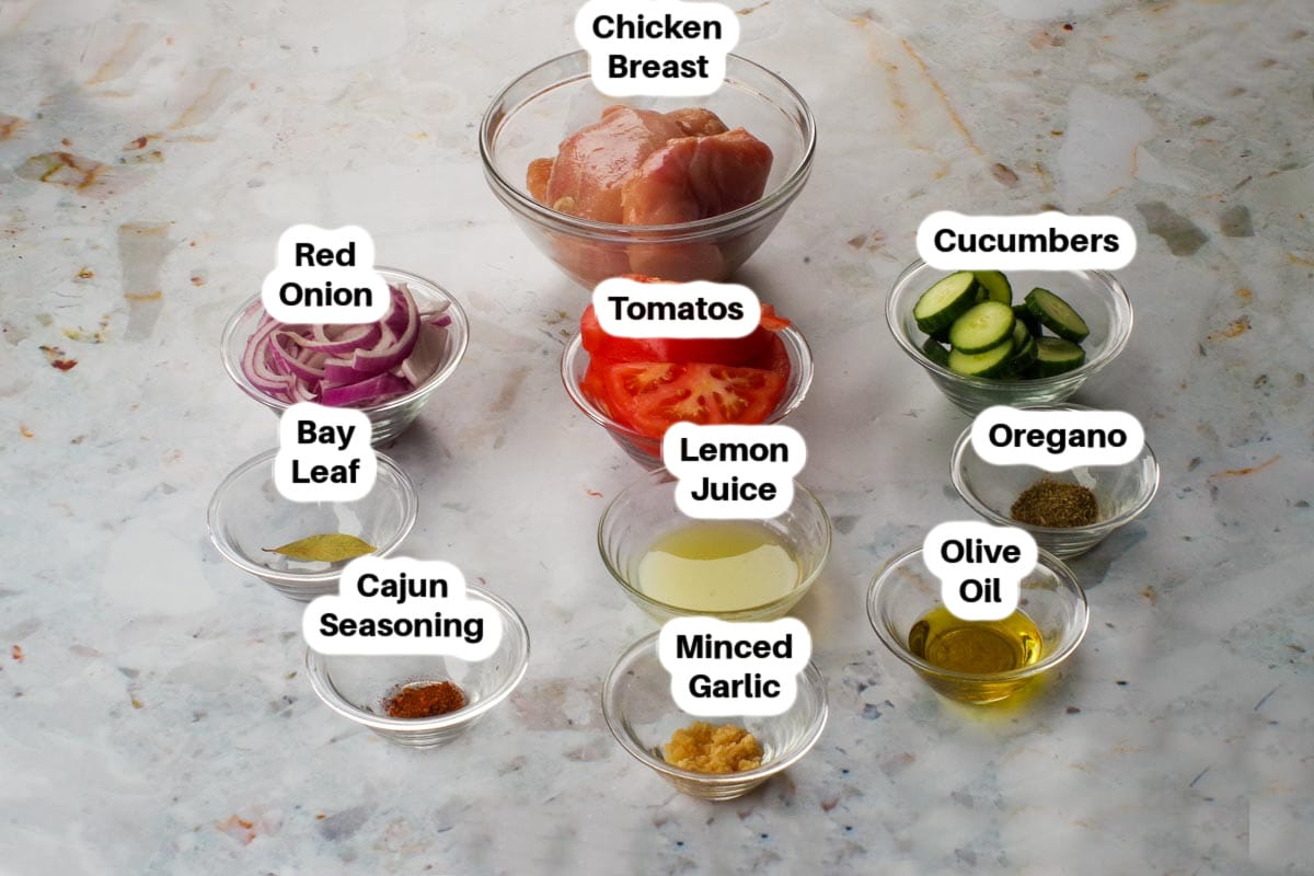 Lazy Greek Chicken Souvlak ingredients in glass bowls, labelled.