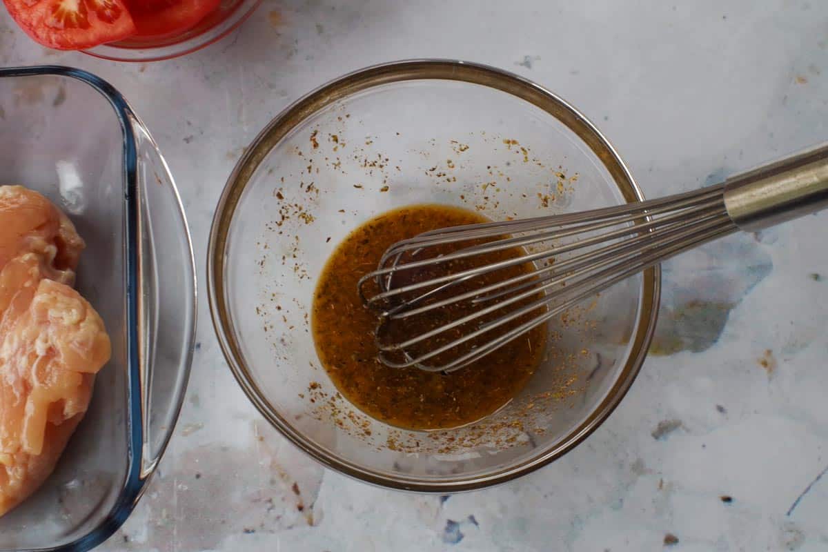 Marinade ingredients whisked together in bowl,