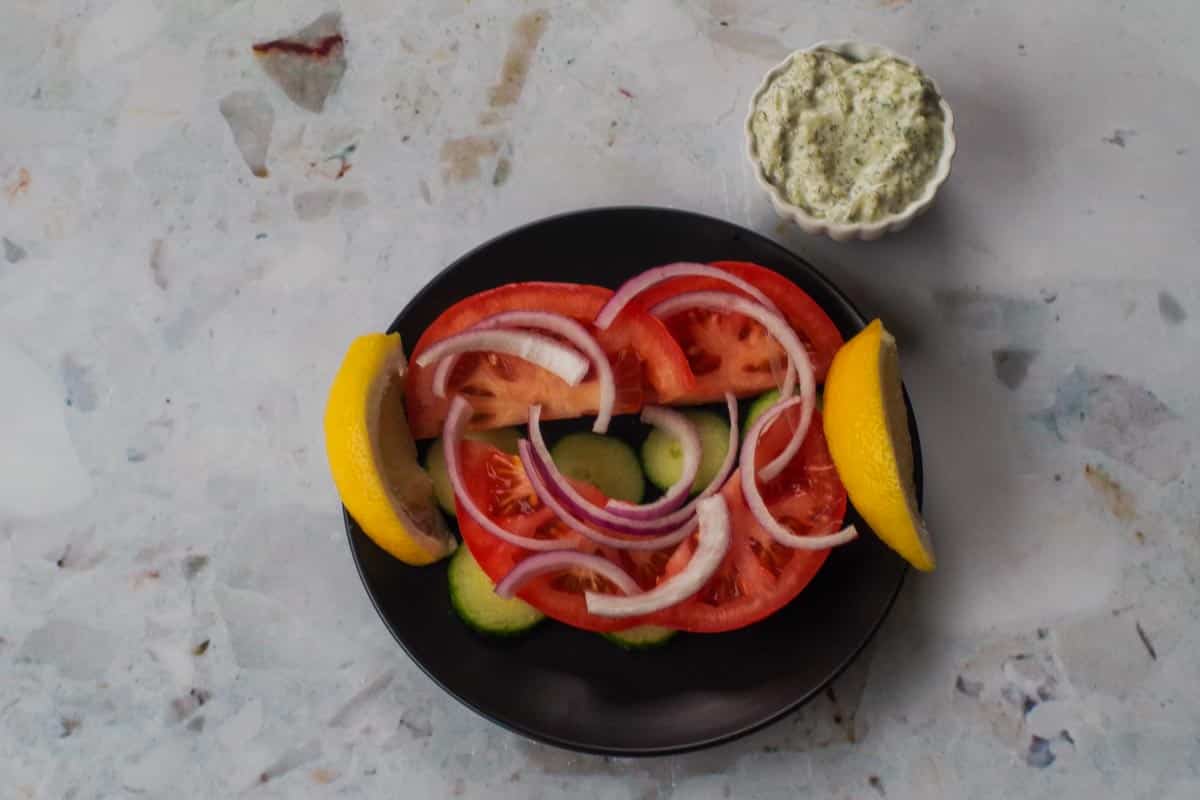 Vegetables on black plate.