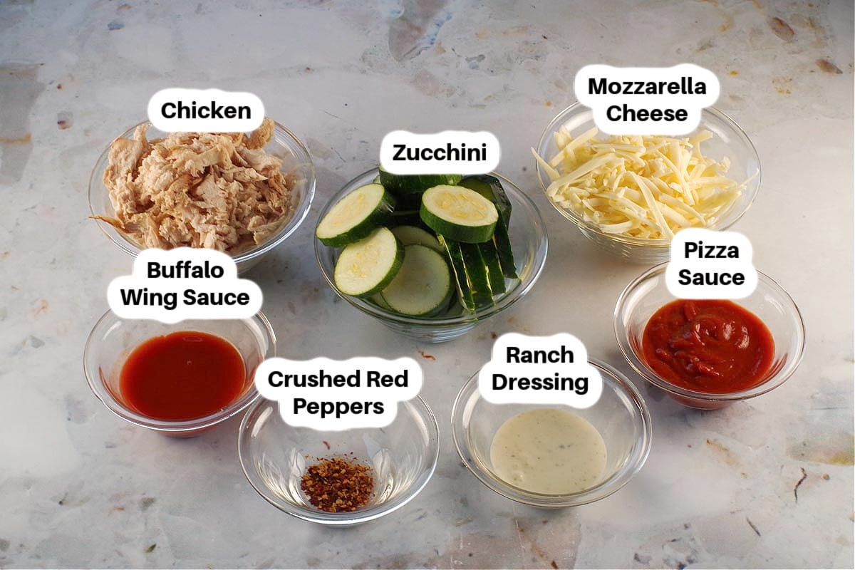 Buffalo Chicken Zucchini Pizza Bites Ingredients in glass bowls, labelled.