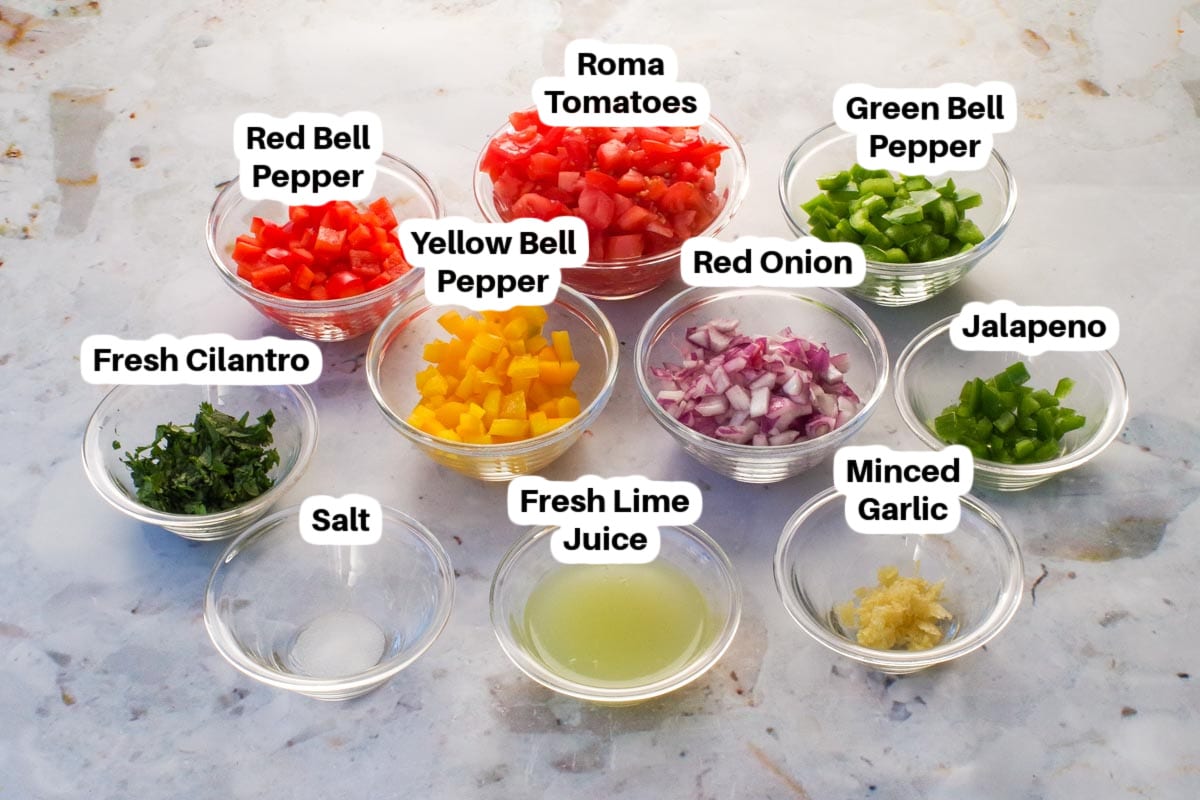Ingredients needed for Pico de Gallo Salsa in glass bowls, labelled.