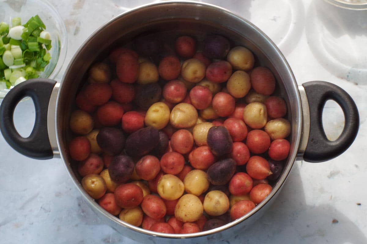 Potatoes in a pot of water.