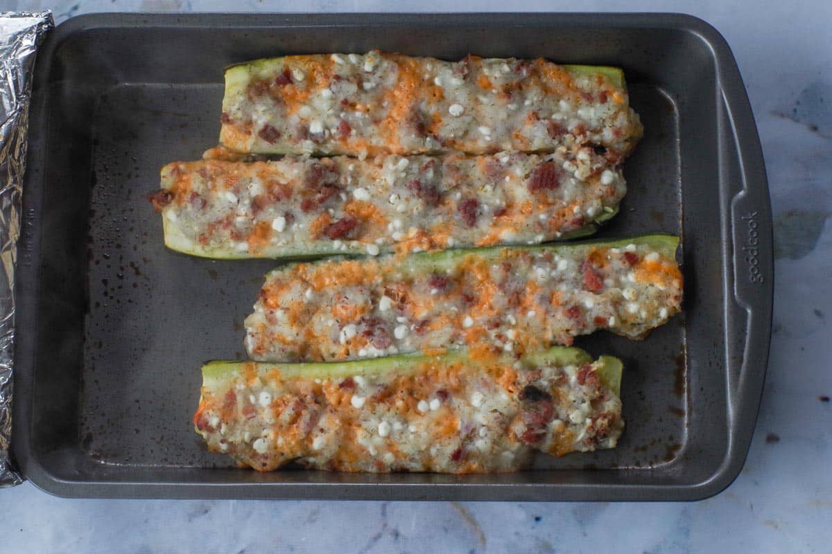 Baked pierogi zucchini in a baking dish.