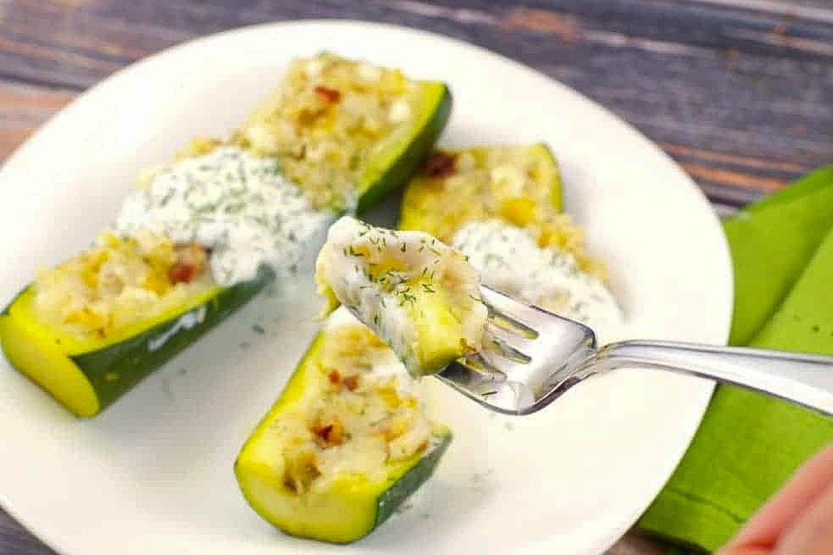 2 Pierogi Stuffed Zucchini on a white plate.