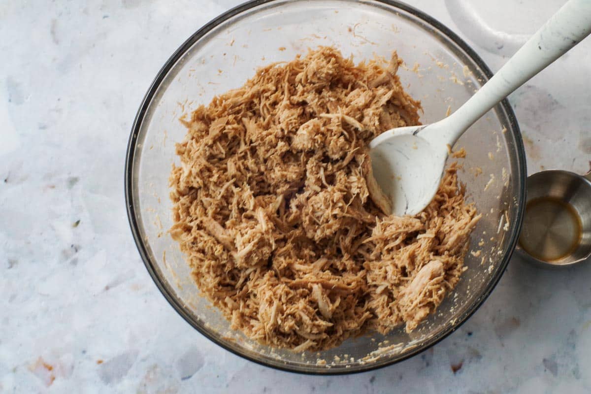 Liquid mixed back into shredded chicken.