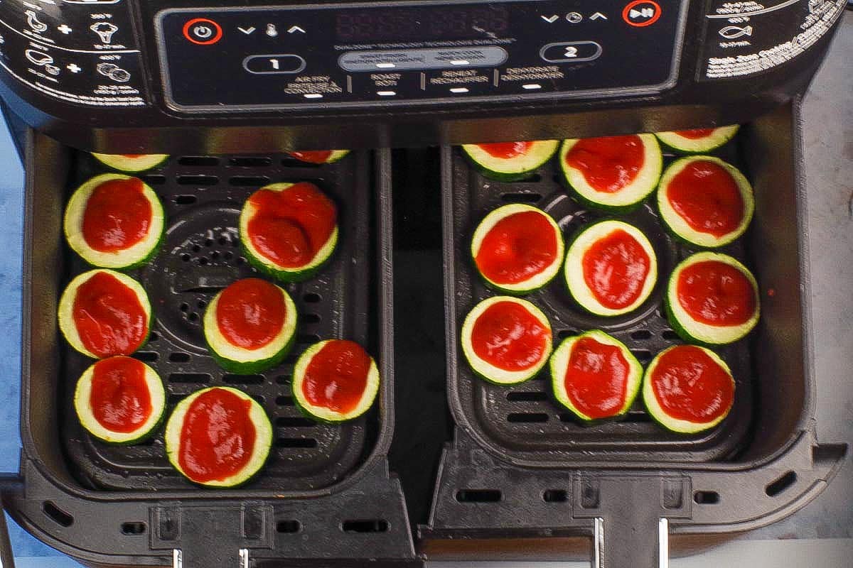 Pizza sauce added to each zucchini bite.