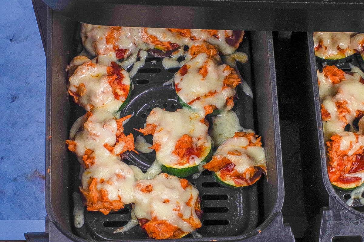 Cooked zucchini pizza bites in air fryer.