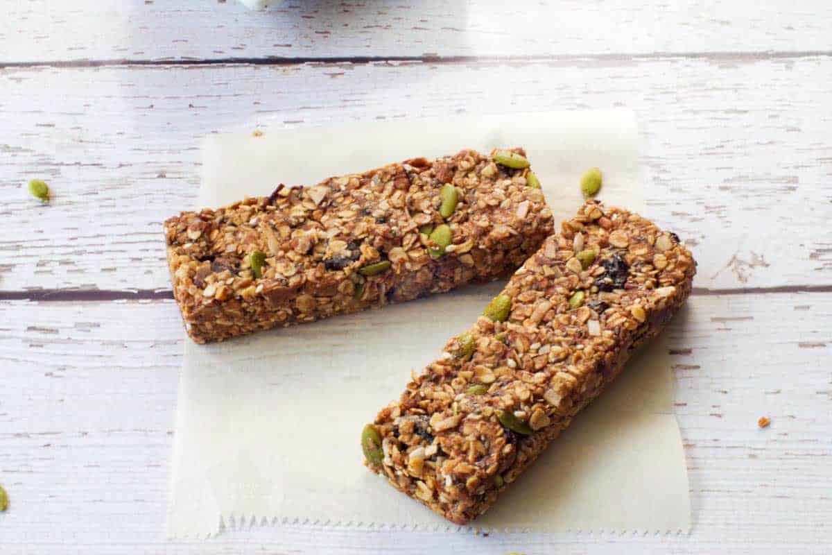 2 No Bake Almond Butter Granola Bars on a piece of parchment paper.