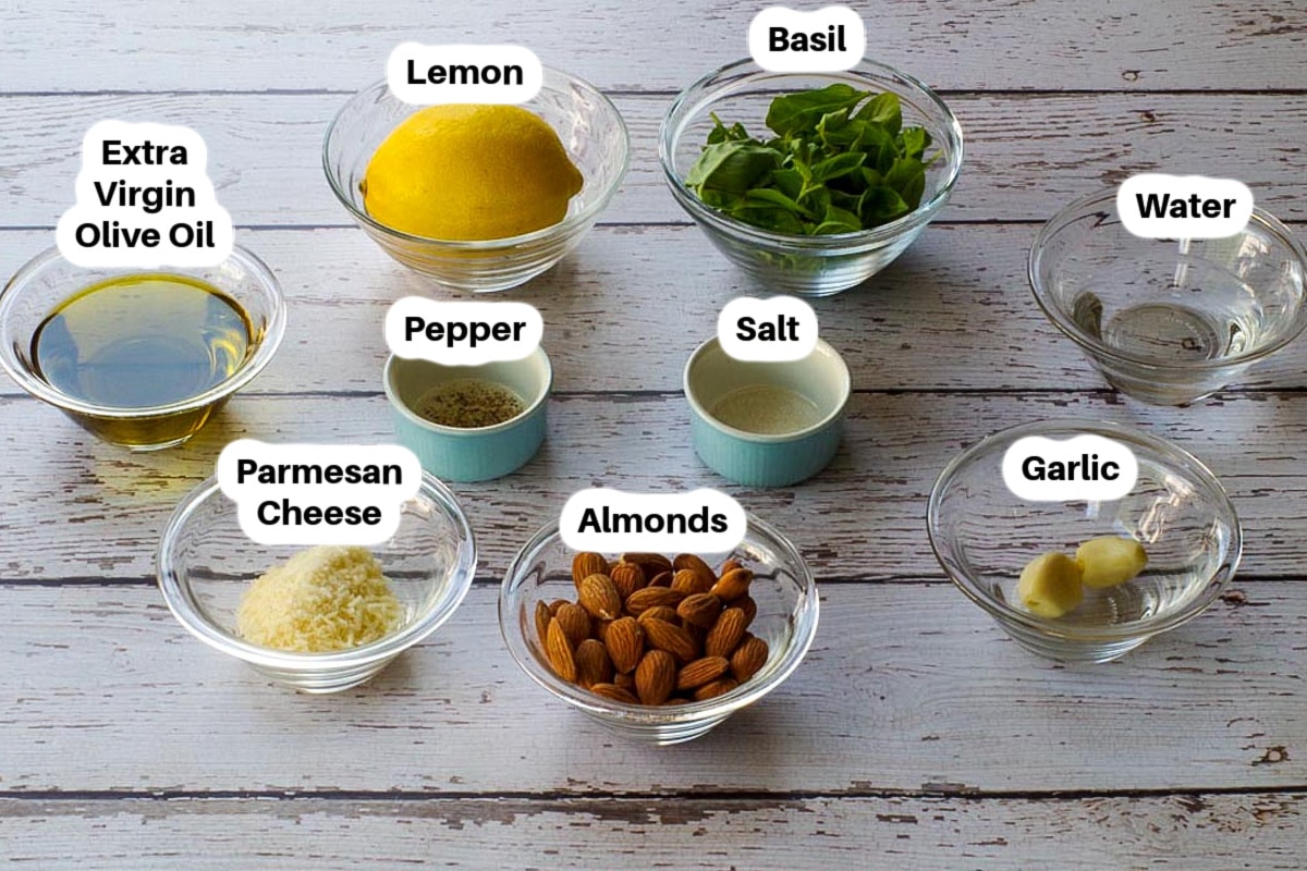 Ingredients in Basil Pesto with Almonds in glass bowls, labelled.