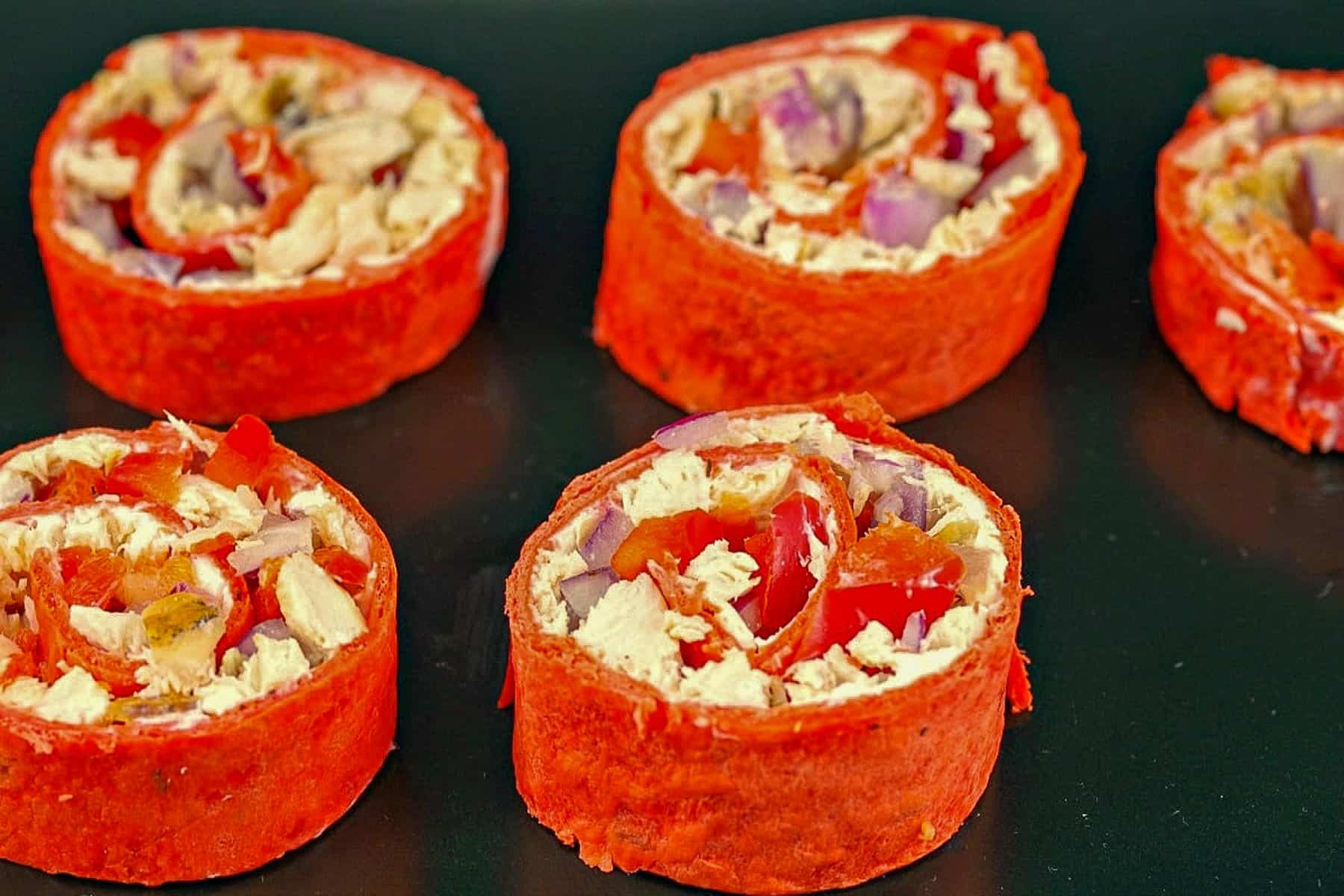 Chicken Tortilla Pinwheels on a black tray
