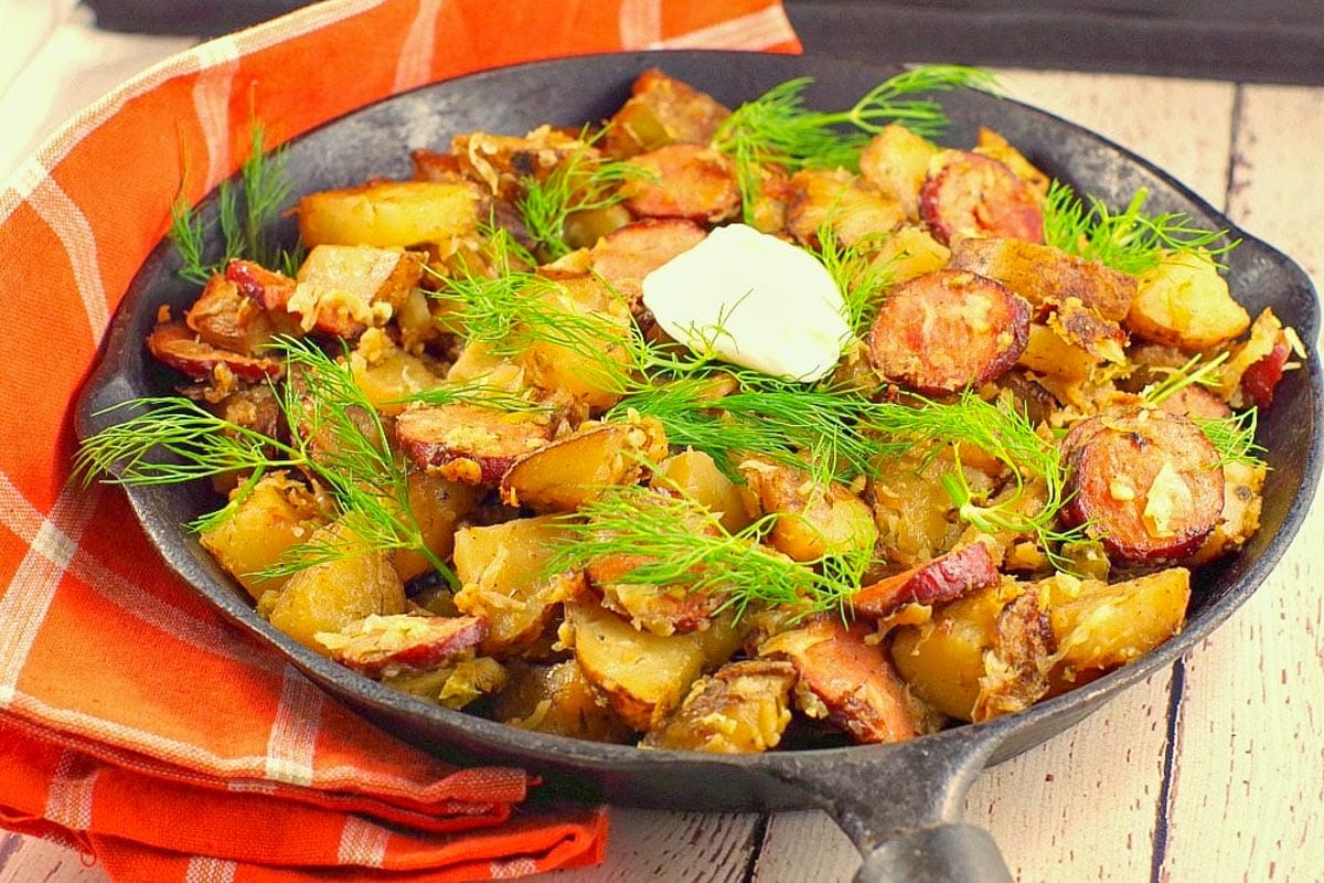 Ukrainian Breakfast Hash in a cast iron frying pan .