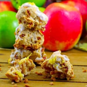 3 Apple Pie Cookies stacked with a split cookie in the front and apples in the background