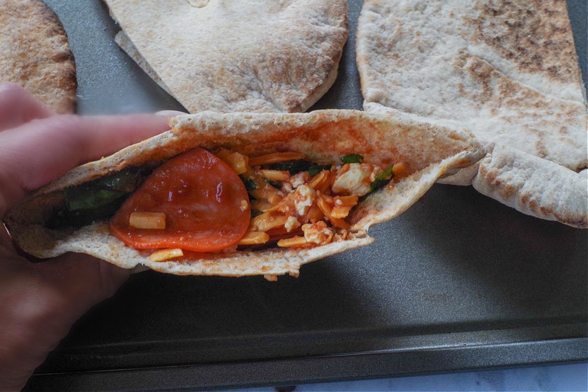 Pita half filled with filling.