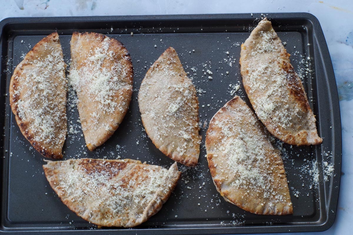Parmesan cheese sprinkled over the hot pockets/pizza pockets