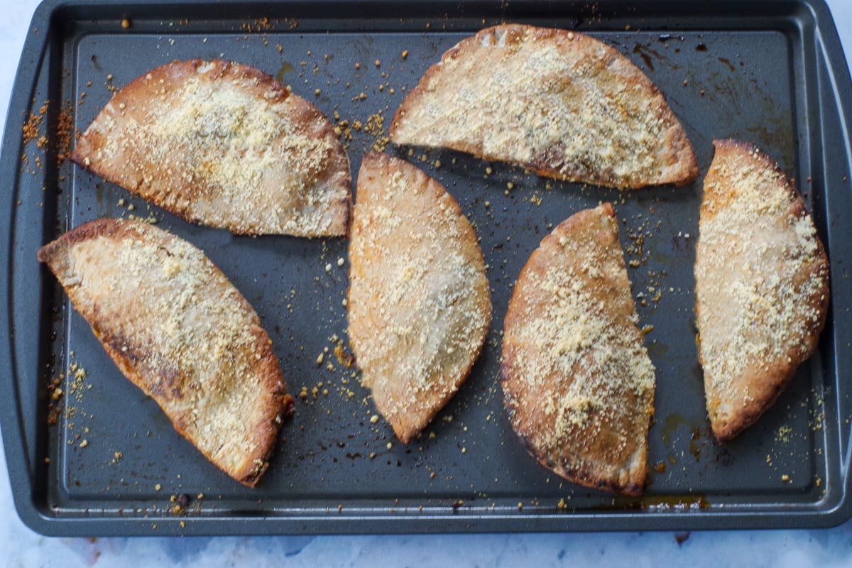 Baked Hot pockets on a baking sheet.