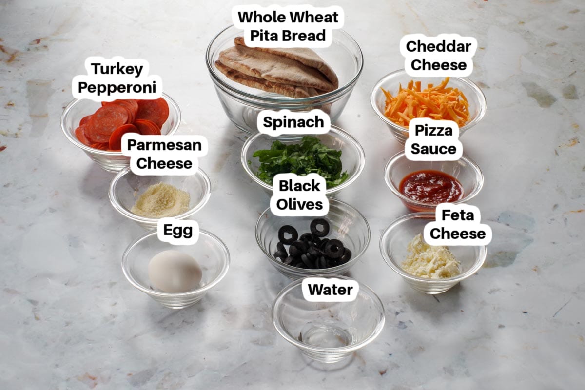 Ingredients in Healthy Pizza Pockets in glass bowls, labelled.