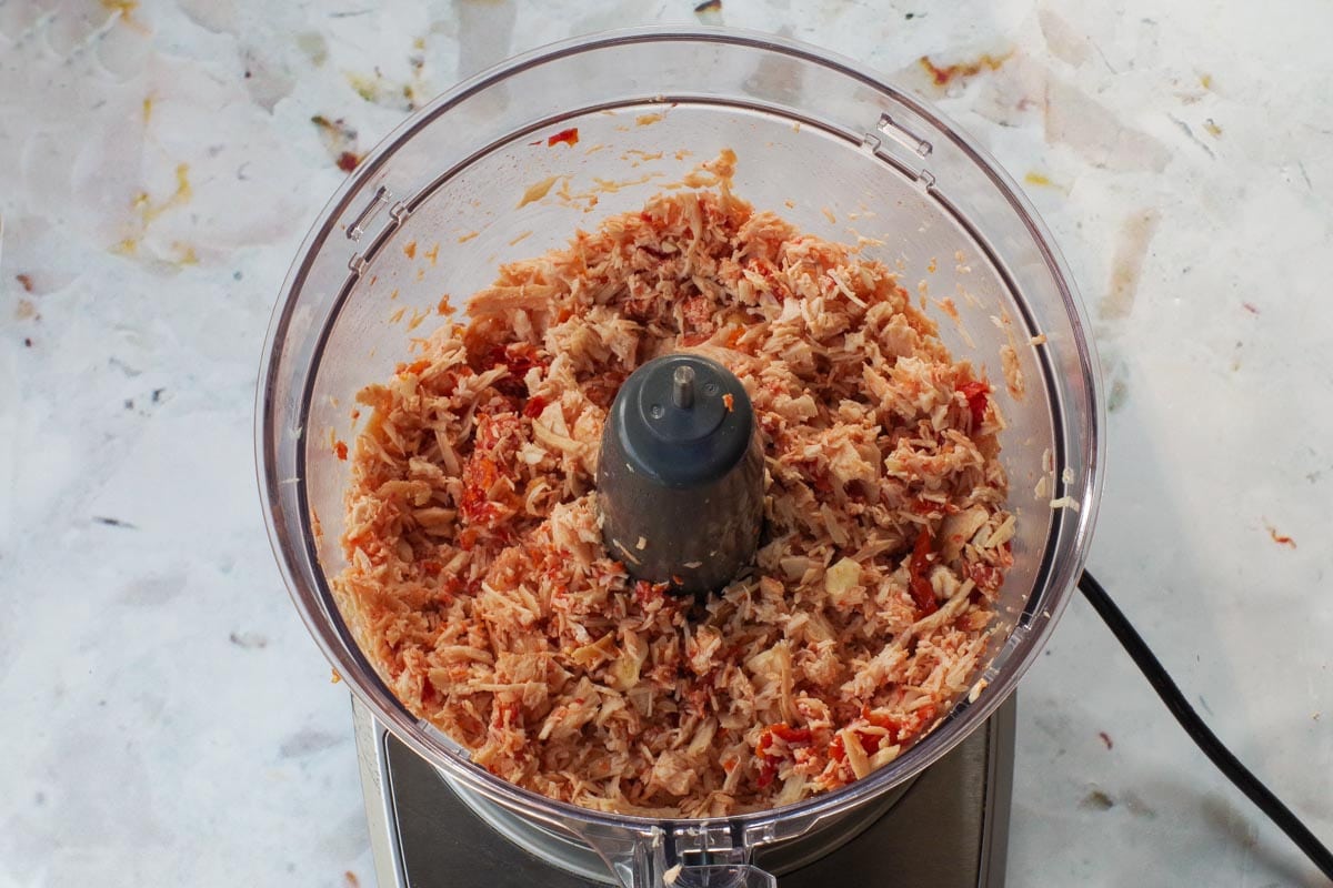 Chicken garlic and sun-dried tomatoes in food processor.