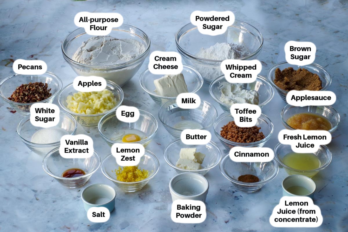 Ingredients in Toffee Apple Pie Cookies in glass bowls, labelled.