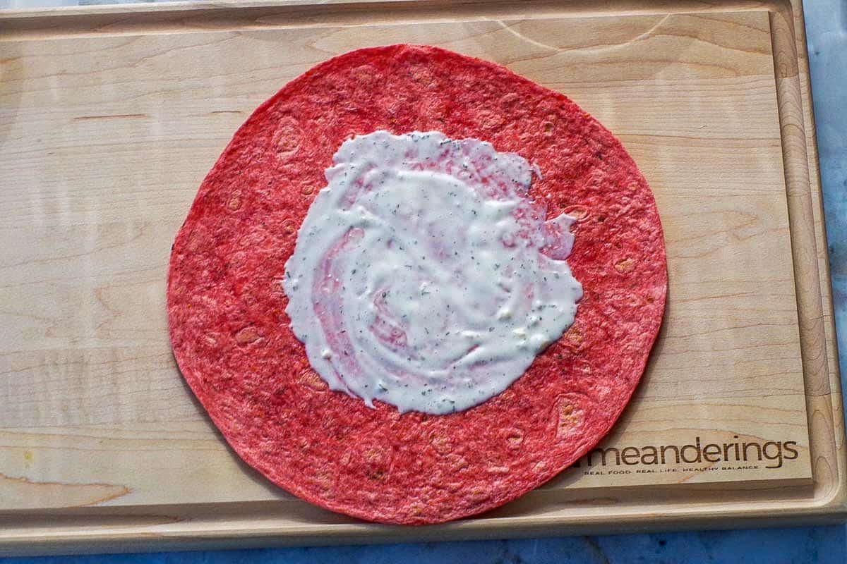 Tomato wrap with ranch dressing spread in the middle.