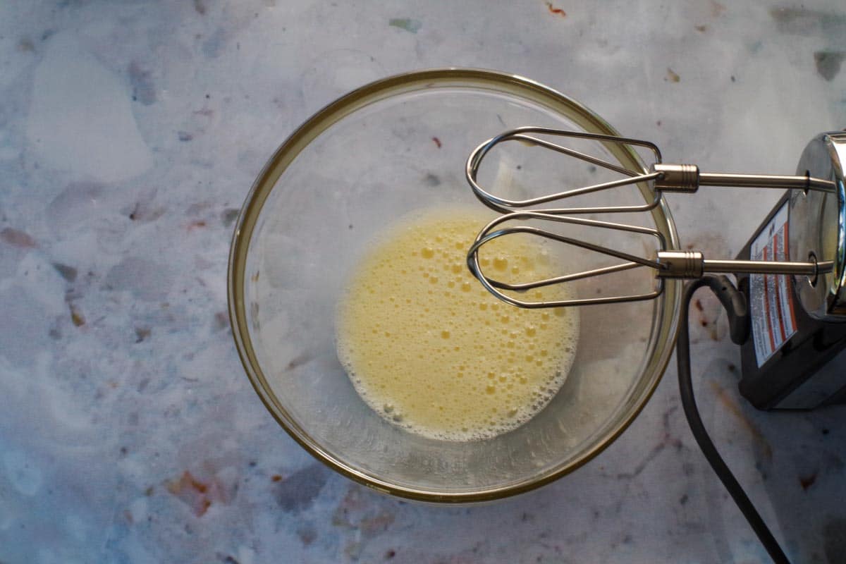 Egg and Oil beaten together in a medium glass bowl.