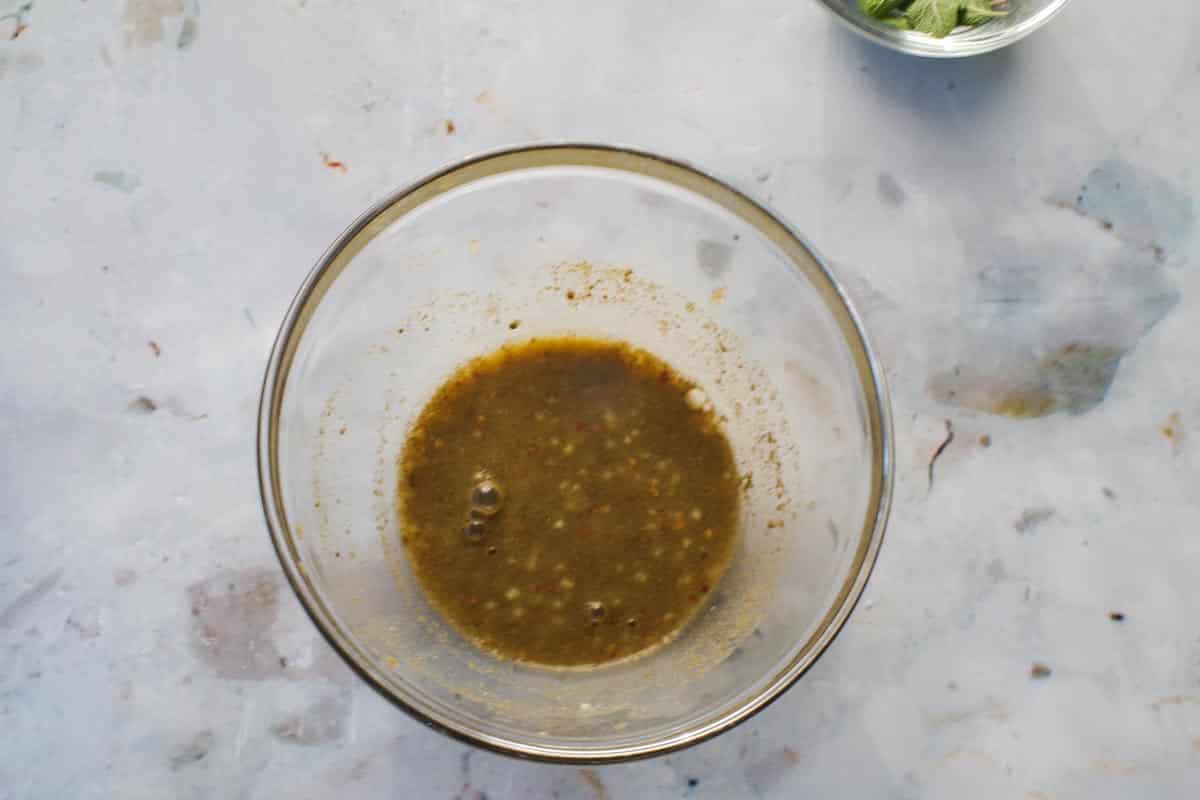 Sauce ingredients whisked together in small glass bowl.