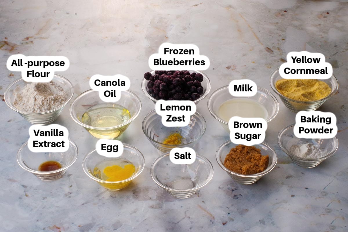 Ingredients needed for Blueberry Cornbread in glass bowls, labelled.