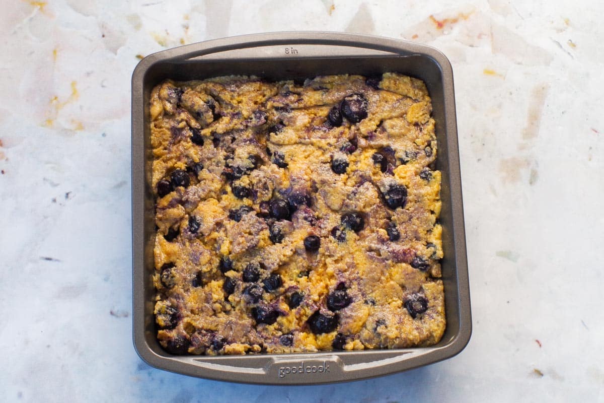 Blueberry cornbread batter in 8 inch pan.