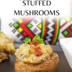 Cheesy Potato Stuffed Mushrooms appetizer on a black serving tray with a Ukrainian print towel in the background.