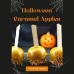 3 Halloween Caramel Apples on a black tray with a plastic jack o' lantern in the background.