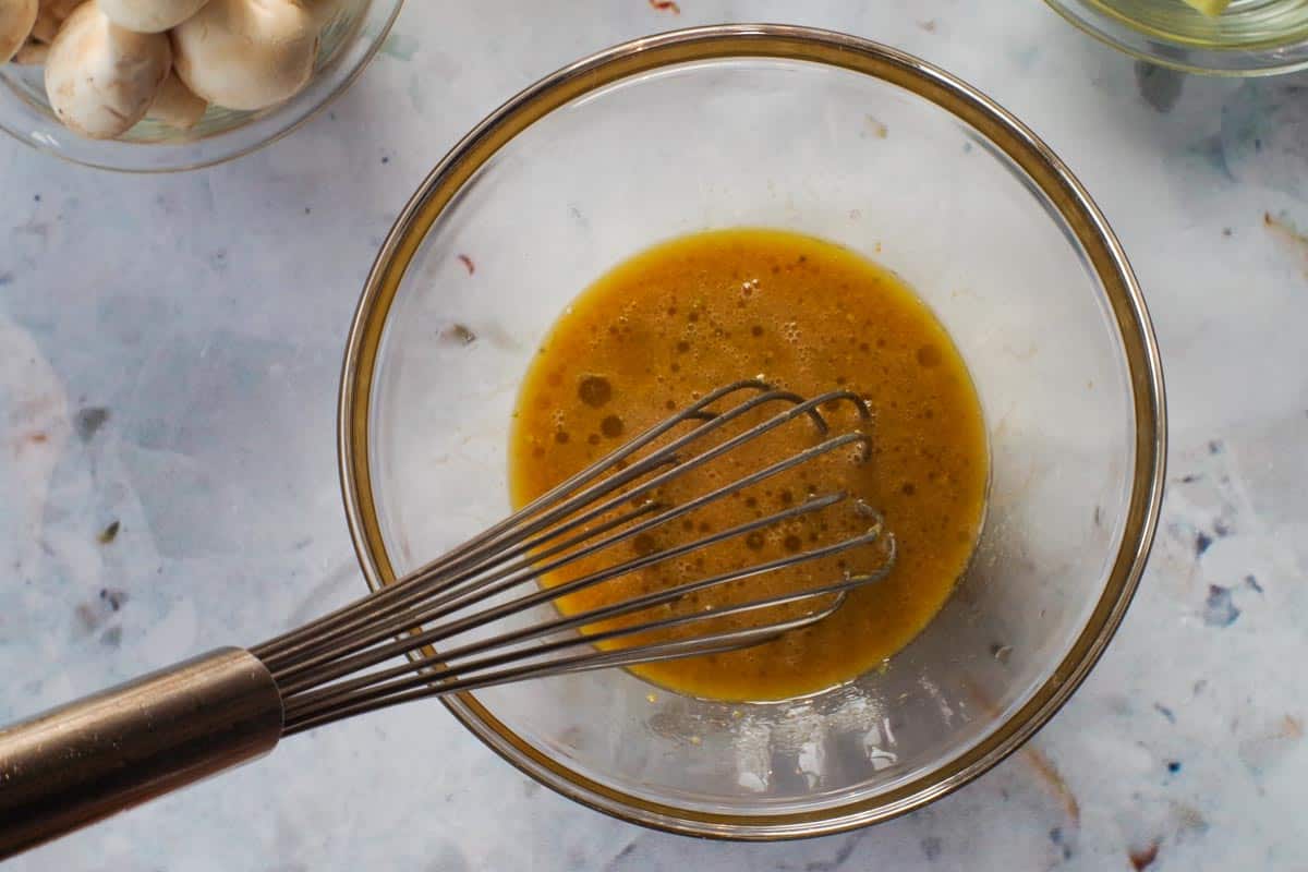 Maple Marinade mixed together in glass bowl with whisk.