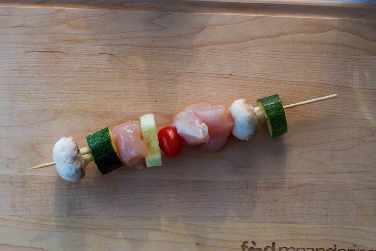 meat and vegetables added to skewer