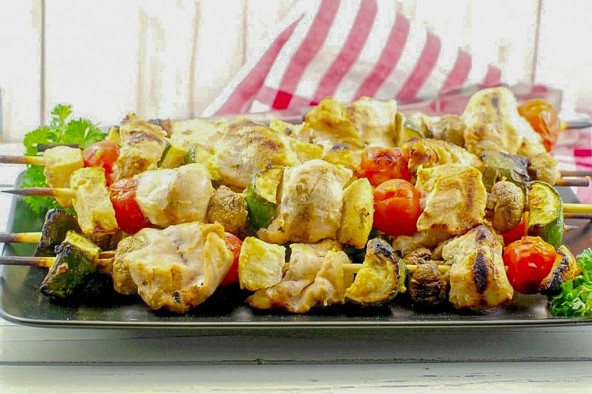 Maple Marinated Grilled Chicken Kabobs on a black tray.